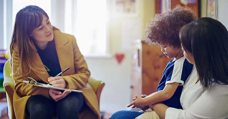 Therapist talking to mother and child