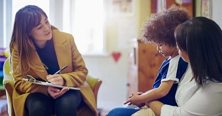 Therapist talking to mother and child